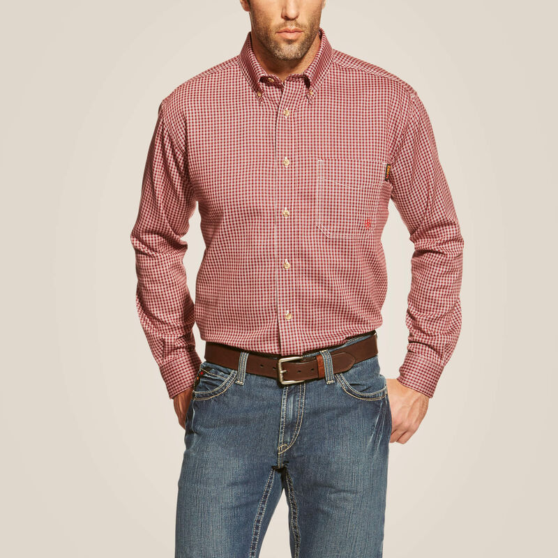 A man wearing Ariat button down FR work shirt in wine color