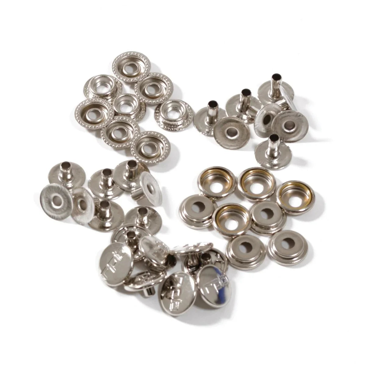 Collection of metal snap buttons on a white background