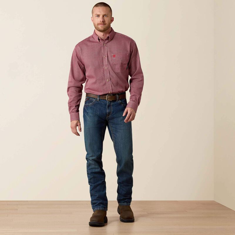 A man wearing Ariat FR straight leg jean with a checkered shirt