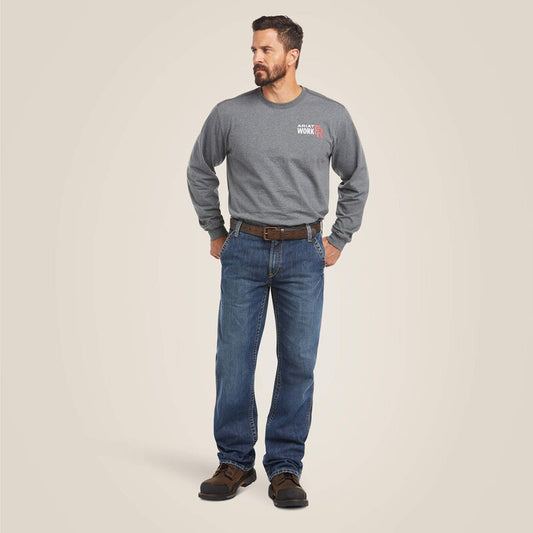 A man wearing Ariat FR M4 Boot Cut Jean with a grey top