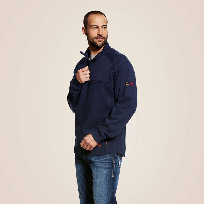 A man wearing ariat 1/4 zip FR pullover in navy color