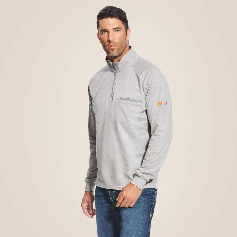 A man wearing ariat 1/4 zip FR pullover in  grey color