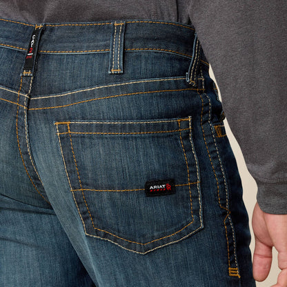 Close up of a man wearing Ariat FR duralight boot cut jean showing back pocket