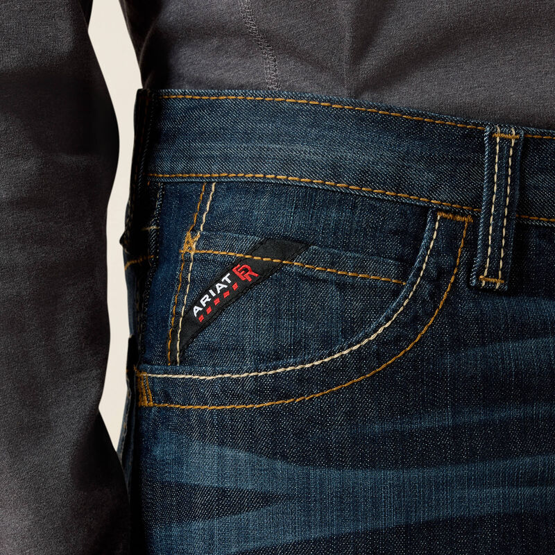 Close up of a man wearing Ariat FR duralight boot cut jean showing front pocket