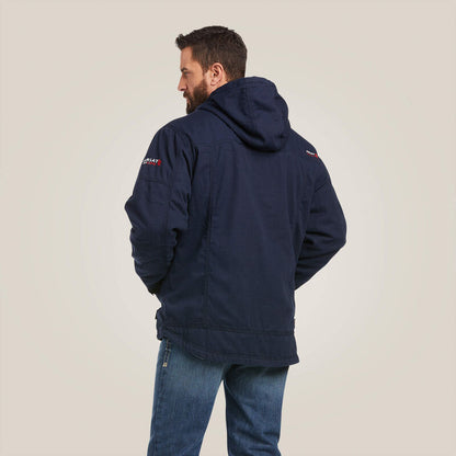 Back view of a man wearing blue Ariat stretch FR jacket 