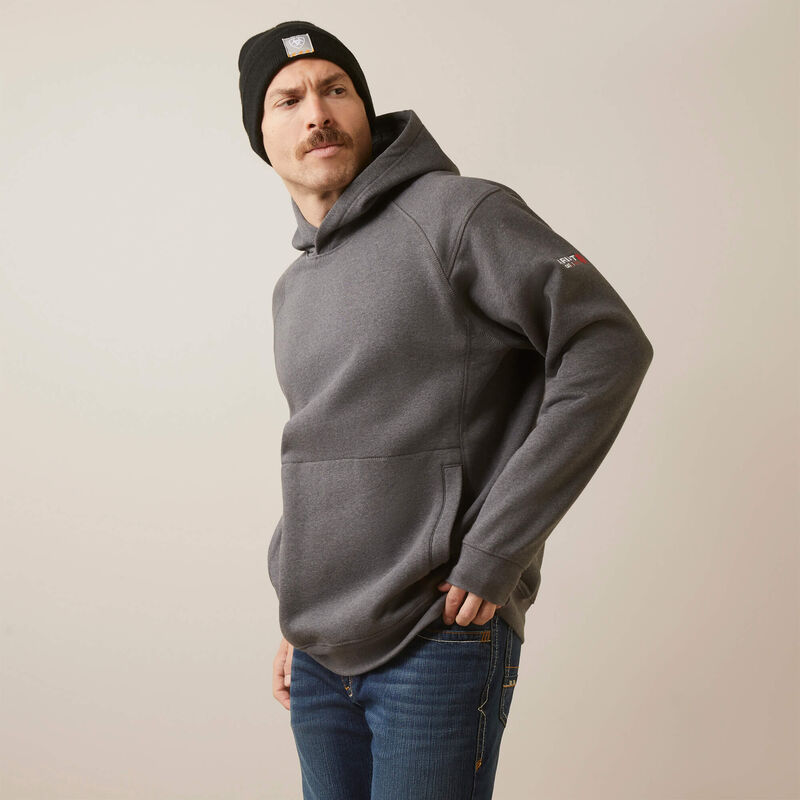 Side view of a man wearing Ariat FR pullover hoodie in dark grey