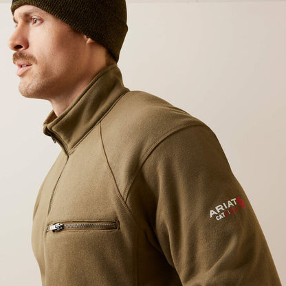 Sideview close up of a man wearing ariat 1/4 zip FR pullover in brown color