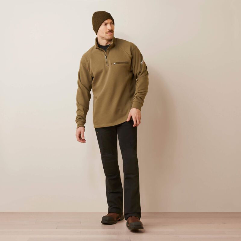 A man wearing ariat 1/4 zip FR pullover in brown color