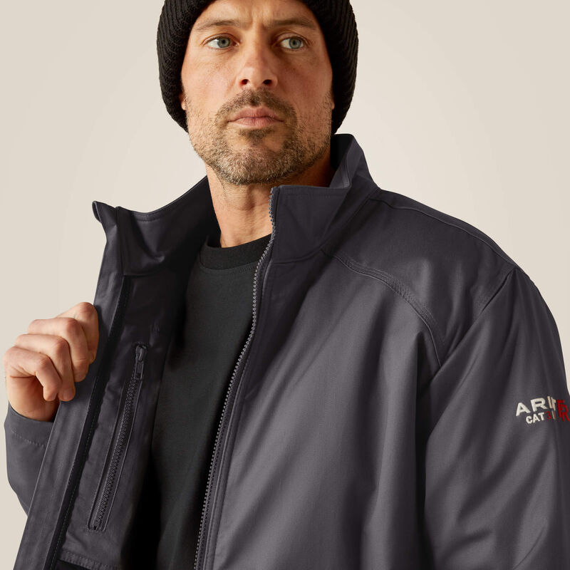 Close up of a man wearing Ariat FR insulated jacket in grey