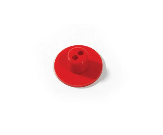 Red plastic button with two holes on a white background